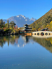 Obraz premium Black dragon pool in Lijiang Ancient Town with best views of Jade Dragon Snow Mountain. Famous travelling destination in Yunnan province, China