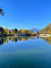 Fototapeta premium Black dragon pool in Lijiang Ancient Town with best views of Jade Dragon Snow Mountain. Famous travelling destination in Yunnan province, China