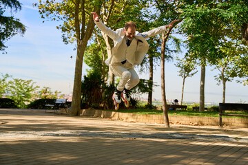 Fototapeta premium Man performing a jump on roller skates in a sunny park