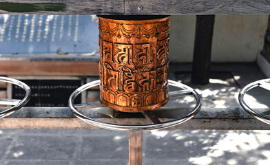 Buddhist Scriptures on Tibetan copper prayer wheel in Sarnath, Varanasi, India