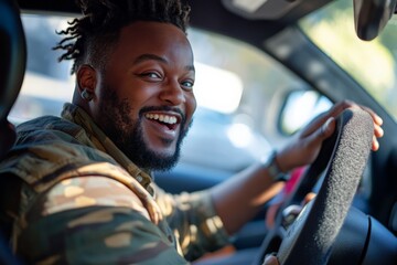 A bearded individual in casual attire smiles confidently while holding the steering wheel of a vehicle, exuding a sense of satisfaction and readiness for adventure.