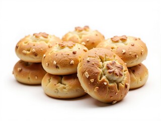Fototapeta premium Small round sweet breads decorated with star shaped cuts and toppings piled on white background