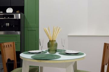 A Contemporary Dining Space Designed with Green Accents and a Chic, Elegant Table Setting
