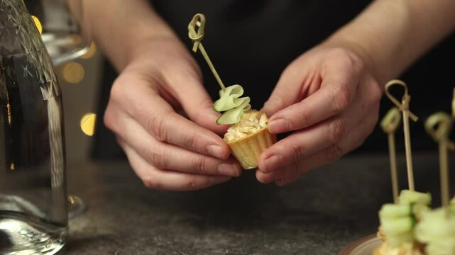 a woman prepares tartlets in the kitchen for the arrival of guests. The concept of preparing for the celebration