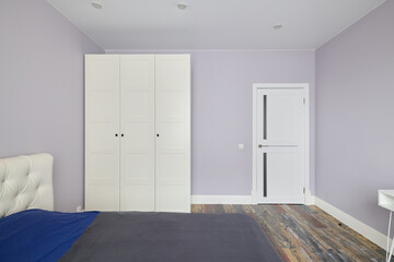 A Modern and Minimalist Bedroom featuring Soft Purple Walls that evoke serenity and style