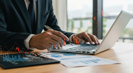 Businessman analyzing a stock market report with a financial virtual chart.