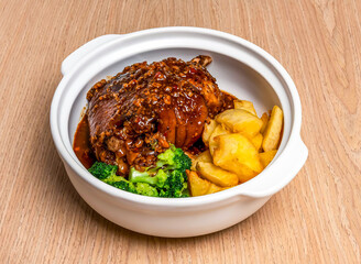 Braised Pork trotter with black pepper casserole, broccoli and wedges served in broth dish isolated on wooden table side view of hong kong food