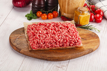 Raw minced beef meat over board