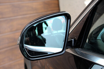 Black car Rearview car driving mirror. View from inside the car. Side rear-view mirror on a modern car. Look rear view mirror.