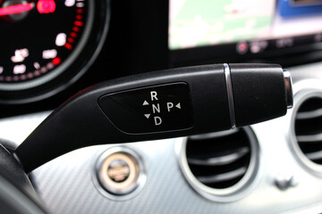 Automatic transmission gear shift in modern car close up. Gearbox shift handle. Automatic gear...