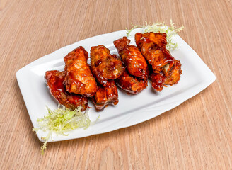 Peking Pork ribs and salad sauce served in tray dish isolated on wooden table side view of hong kong food