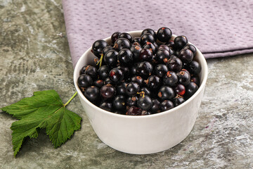 Ripe black currant in the bowl