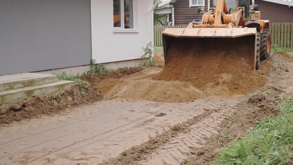 Heavy machinery is leveling and preparing the ground at a busy construction site for future projects