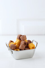 Small Square Cheese and Chocolate Wafer on Stainless Bowl