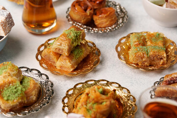 Delightful assortment of traditional pastries served with tea during a festive gathering in a cozy setting