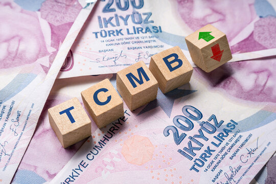Wooden cubes with TCMB (Turkiye Cumhuriyet Merkez Bankasi) and up-down arrows on 200 TL. The concept of TCMB interest rate hike to curb inflation