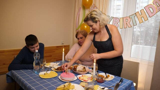 A cake with a candle for 41 years is served to the table. Birthday celebration.