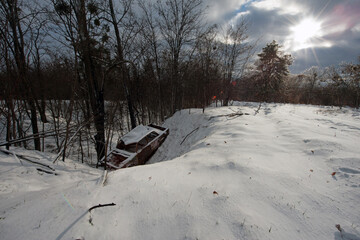 Accident on a winter snowy track. car skidding and falling into a ditch due to ice. Safety and poor driving on the road. auto. broken car, accident in the snow, ditch. the car burned down