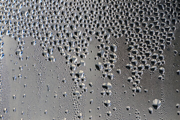 background, unusual, abstract. drops of morning dew, condensation on the glass. wet glass. water drops close-up. beautiful background for text. Spray cool condensate water on the glas