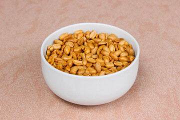 Roasted salted peanut on a white bowl