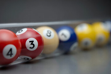 Lottery numbered balls, randomly manually picked, rolled into a transparent tube, selected as the winning combination numbers. Concept for chance, randomness, odds, probability, queueing, FIFO.