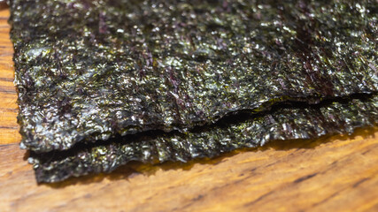 Nori algae leaves on a wooden table closeup