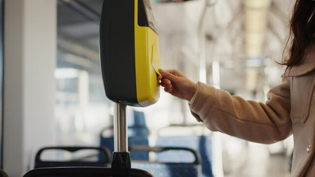 Close-up of a passenger passing ticket at ticket machine wirelessly validating it on a bus ride, showing everyday urban transportation.