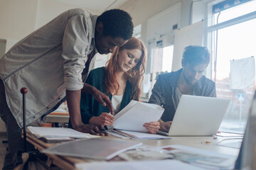 Young people working on a project together in a startup company office