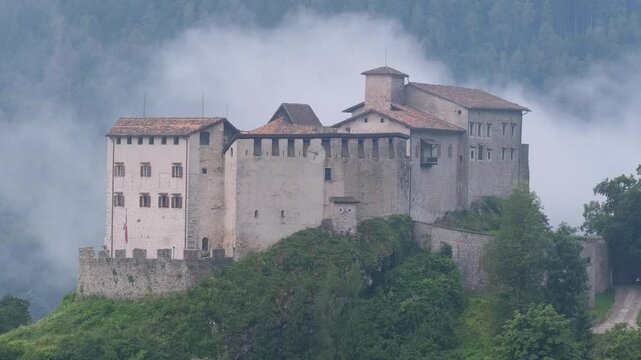 Stenico Castle in Morning Fog: 4K Video of Castello di Stenico, Italy &ndash; Low Clouds, Slow Motion Movement, and Mountain Landscape