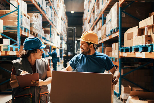 Female warehouse worker inspecting inventory with clipboard