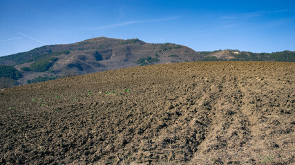 Closeup of a plowed field ready for planting. Cultivations on the hills. Bio agriculture concept.