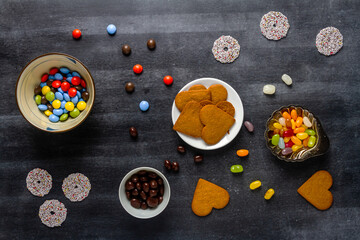 Various sweet food on black chalkboard background. Flat lay. Top view. Food concept.