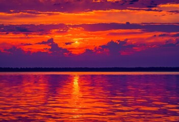 Naklejka premium vibrant purple sunset clouds reflecting over calm waters creating serene nature scene, reflection, colors, orange, pink, evening, sky, horizon, scenic