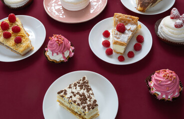desserts with raspberries on white plates on the table