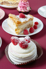 desserts with raspberries on white plates on the table