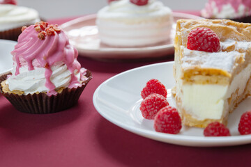 desserts with raspberries on white plates on the table