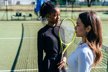 Females tennis players posing with rackets