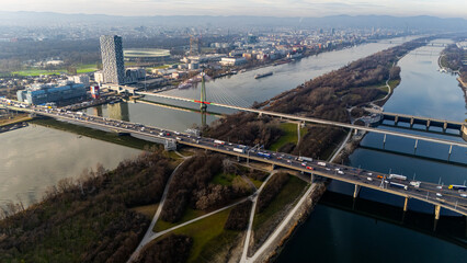 Cinematic Aerial View of Vienna: Danube River, Iconic Bridges, and Cityscape. A stunning drone shot capturing Vienna's Danube River, its iconic bridges, and the city's scenic skyline from above.