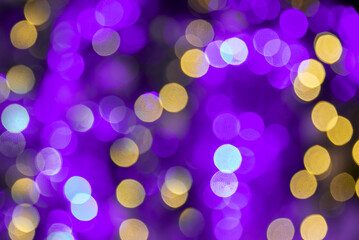 Purple and gold bokeh holidays lights at night, Mardi Gras carnival christmas or new year party...