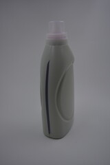 Items, household chemicals, things for cleaning and cleaning. Matte grey bottle with clear lid and large plastic handle and bright purple liquid, cleansing gel.