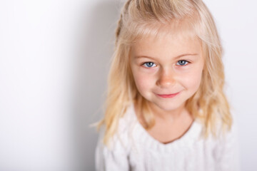 A Cute girl 5 year old posing in studio