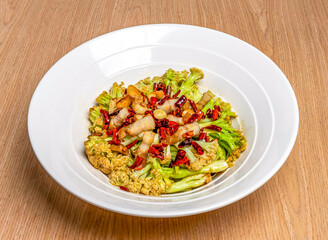 Sichuan Stir Fried Cauliflower served in bamboo steamer isolated on wooden table side view of hong kong food