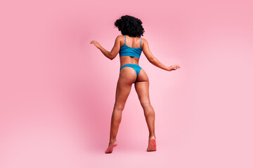 Back view photo of energetic woman moving feeling comfort in blue lingerie isolated pastel color background