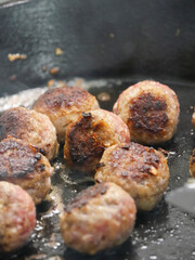 The process of making meatballs. Meatballs cooking in a cast irom pan on the stove. Fresh meatballs. Swedish meatballs, cuisine.