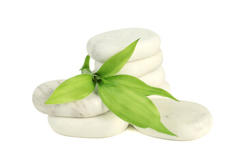 Spa stones and green leaves isolated on white