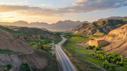 Asphalt road with green mountain nature landscape in Xinjiang at sunset, China. 