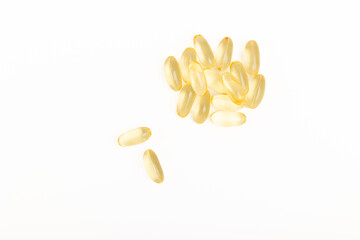 Yellow gelatin capsules isolated on white background