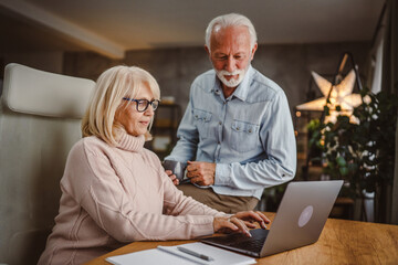 Senior husband take care of his wife while she work at home