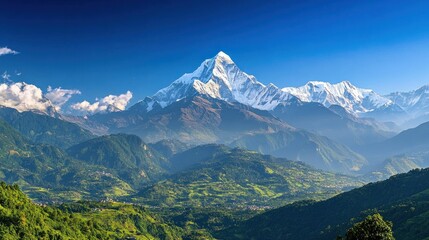 Fototapeta premium Majestic mountain landscape with snow-capped peaks and lush valleys under a clear blue sky.