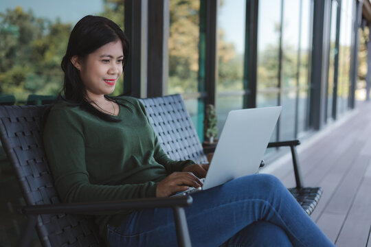 Business Woman typing on laptop computer keyboard in coffee shop. Business concept. Working away from the office. Businessman analyzing company performance graph to generate profit and growth.